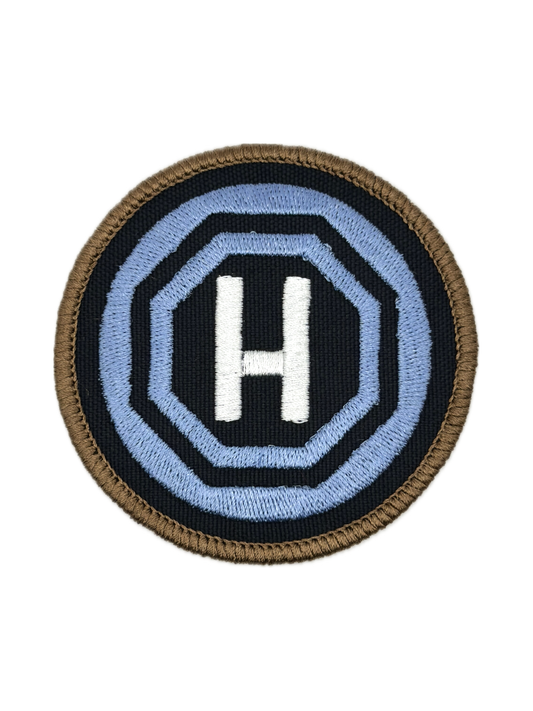 Circular home teleport patch with letter 'H' in the center on a white background