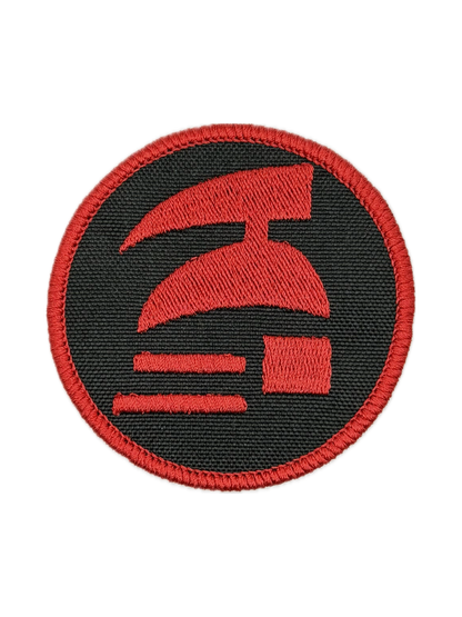 Red and black circular patch with a logo on a white background. Hardcore ironman logo patch.