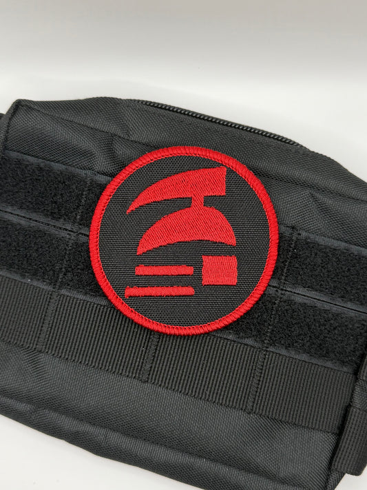Black pouch with a red emblem on a white background. Hardcore ironman logo