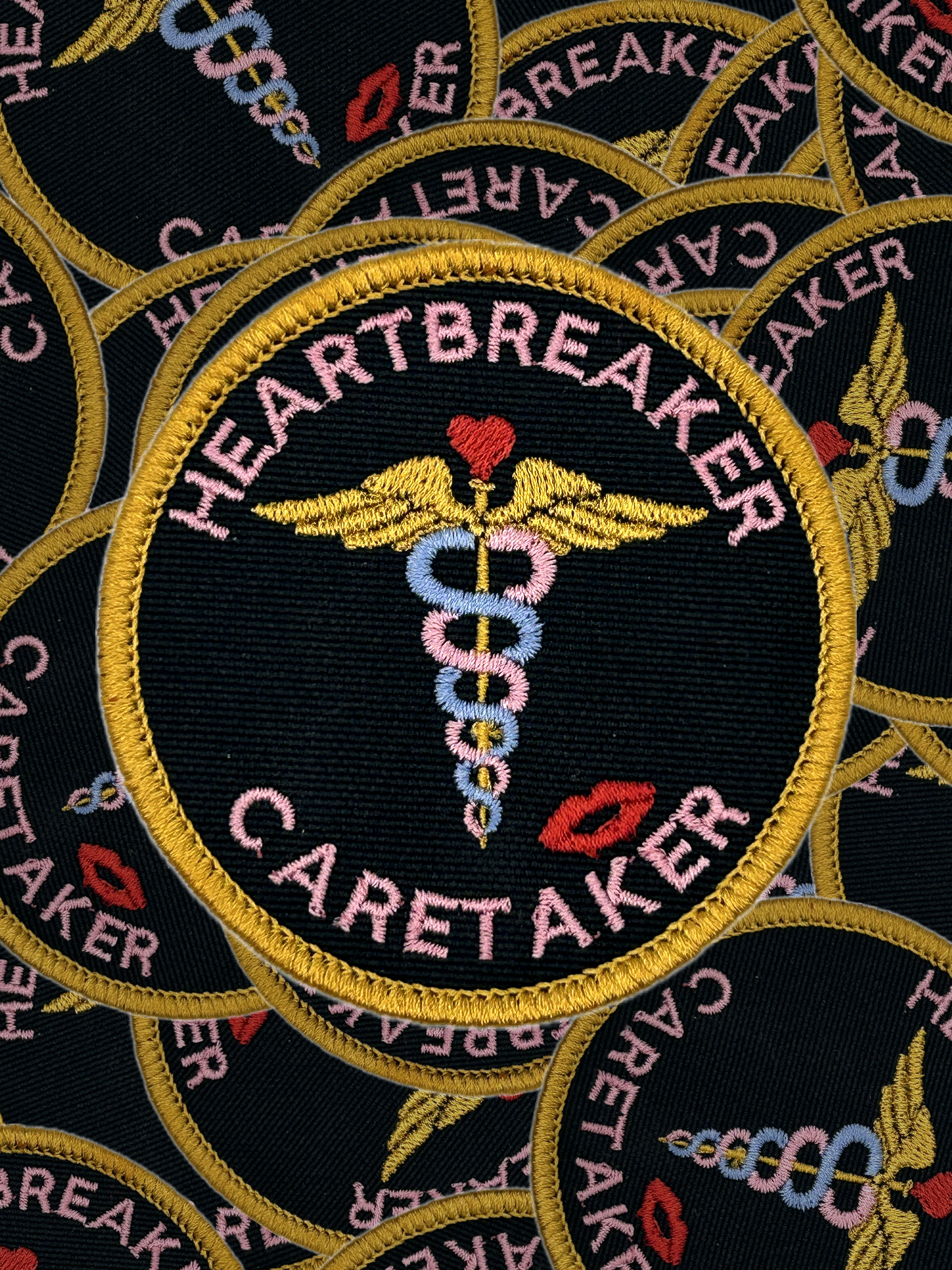 Embroidered patch with 'Heartbreaker Caretaker' design on a black background