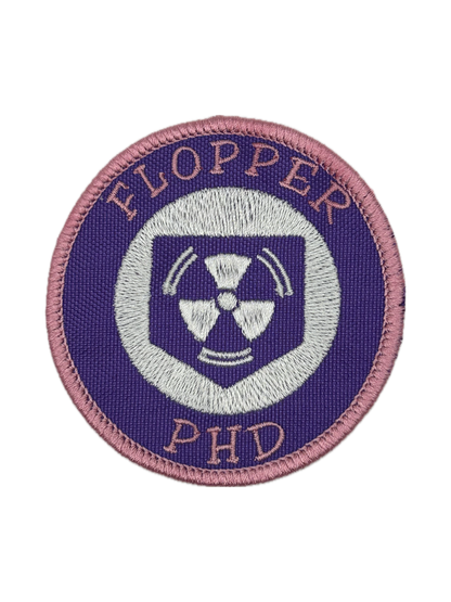 Circular patch with 'FLOPPER PHD' text and a radiation symbol on a white background