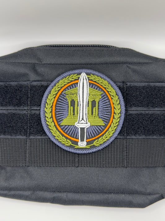 Black tactical vest with a central emblem featuring a sword and wreath on a white background