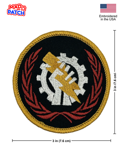 Round patch with gear and hand design, embroidered in the USA, on a white background.