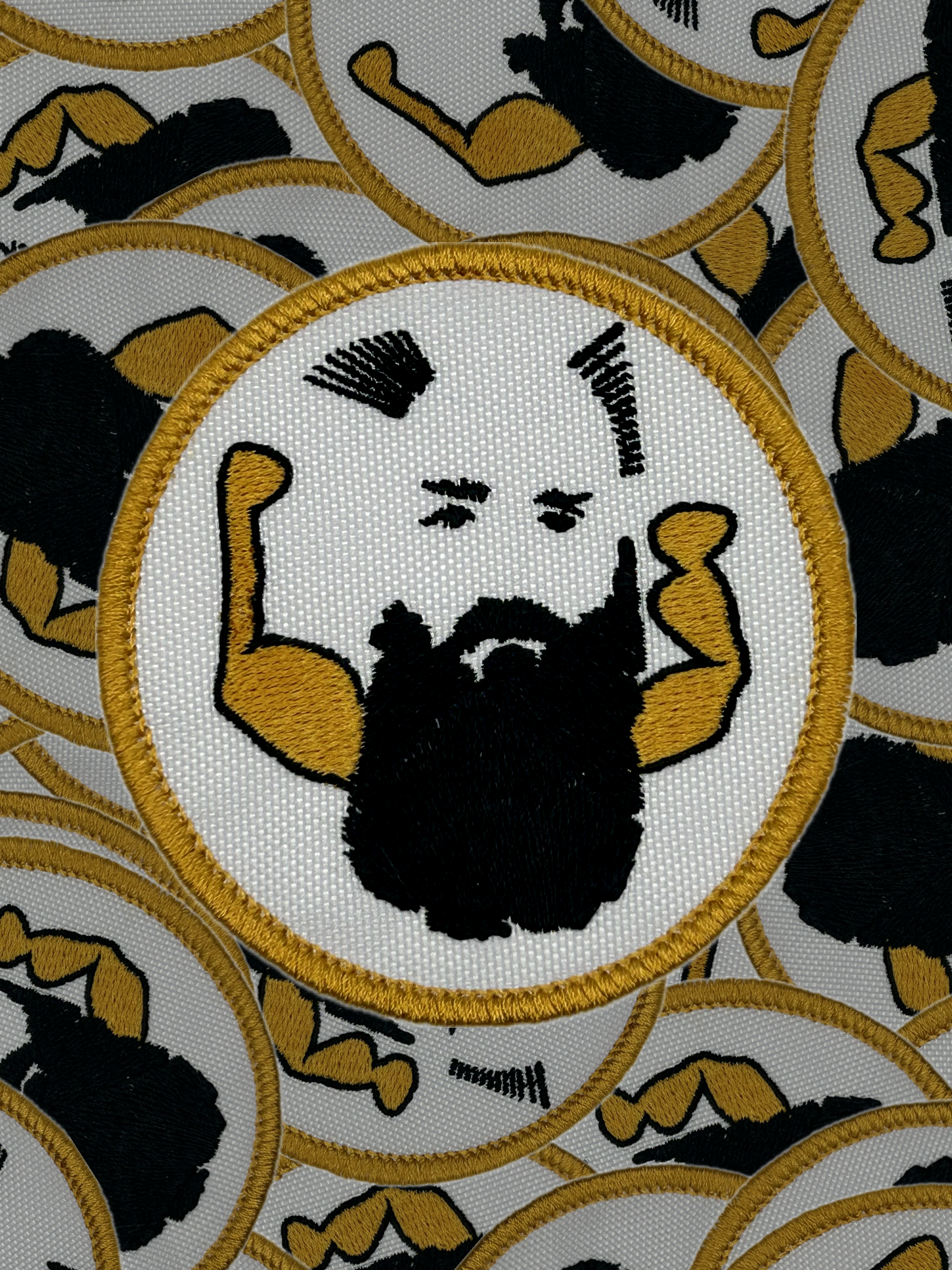 Patch with a stylized face and arms flexing, surrounded by similar patches on a white background.