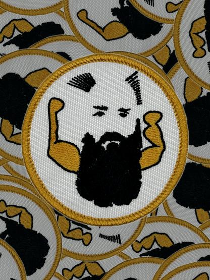 Patch with a stylized face and arms flexing, surrounded by similar patches on a white background.