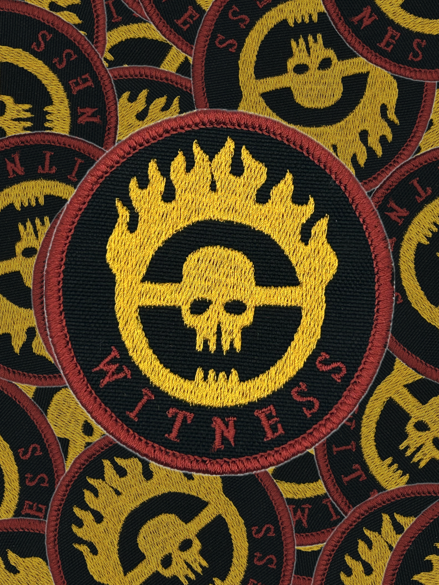 Pattern of 'Witness' war boys patches with skull design on a black background