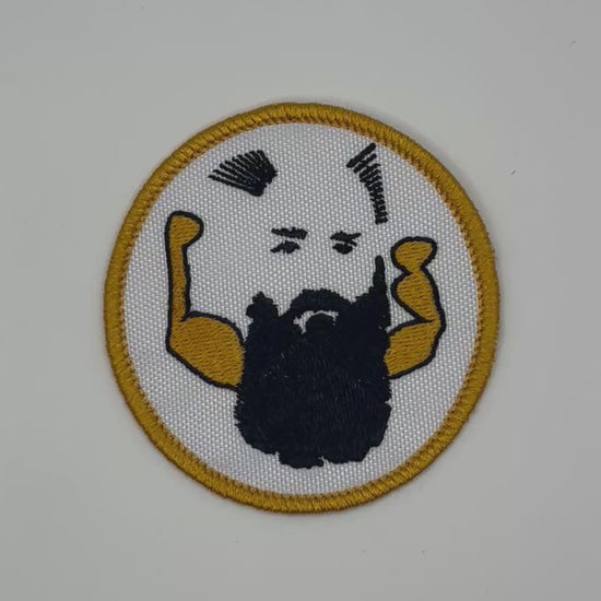 Circular patch with a stylized face and arms on a white background