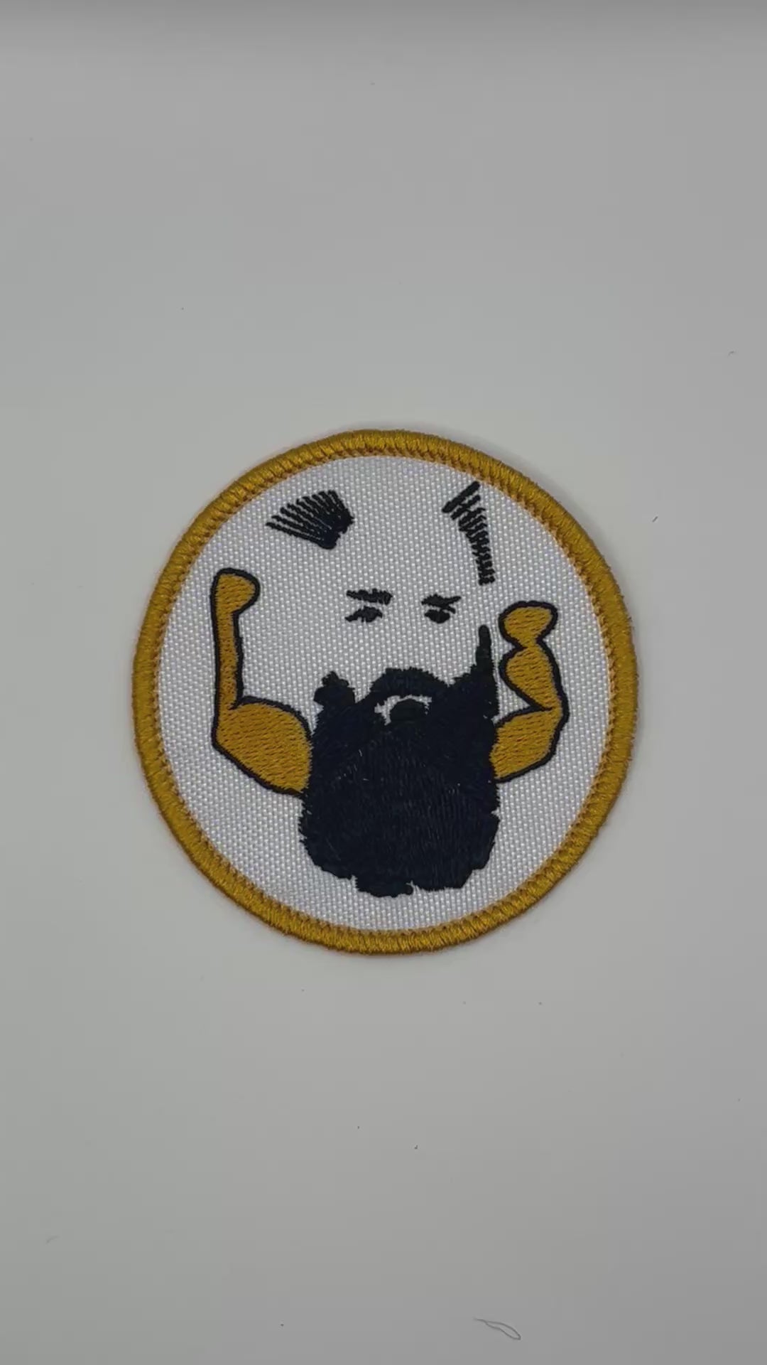 Circular patch with a stylized face and arms on a white background